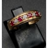 A 9 K yellow gold ring with rubies and diamonds. Ring size: I/J, weight: 2.4 g. In a presentation