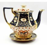 A Linguard Imari Teapot and Plate Stand. Decorated with traditional Imari style pattern with rich