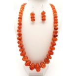 An antique, Tibetan, hand carved, gourd shaped, carnelian necklace and earrings set. On a modern