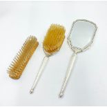 A Vintage Silver Art Deco Style Dressing Table Set. Comprising of a hand-mirror and two brushes.
