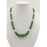 A Graduated Taiwanese Jade and Freshwater Pearl Necklace. Faceted Olive-Green Jade interspersed with