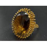 An 18 K yellow gold ring with a massive, oval cut, smoky quartz. Ring size: R, weight: 12.73 g.