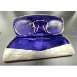 A Victorian solid silver glass case with 9 K yellow gold reading glasses. Made in Birmingham 1886.