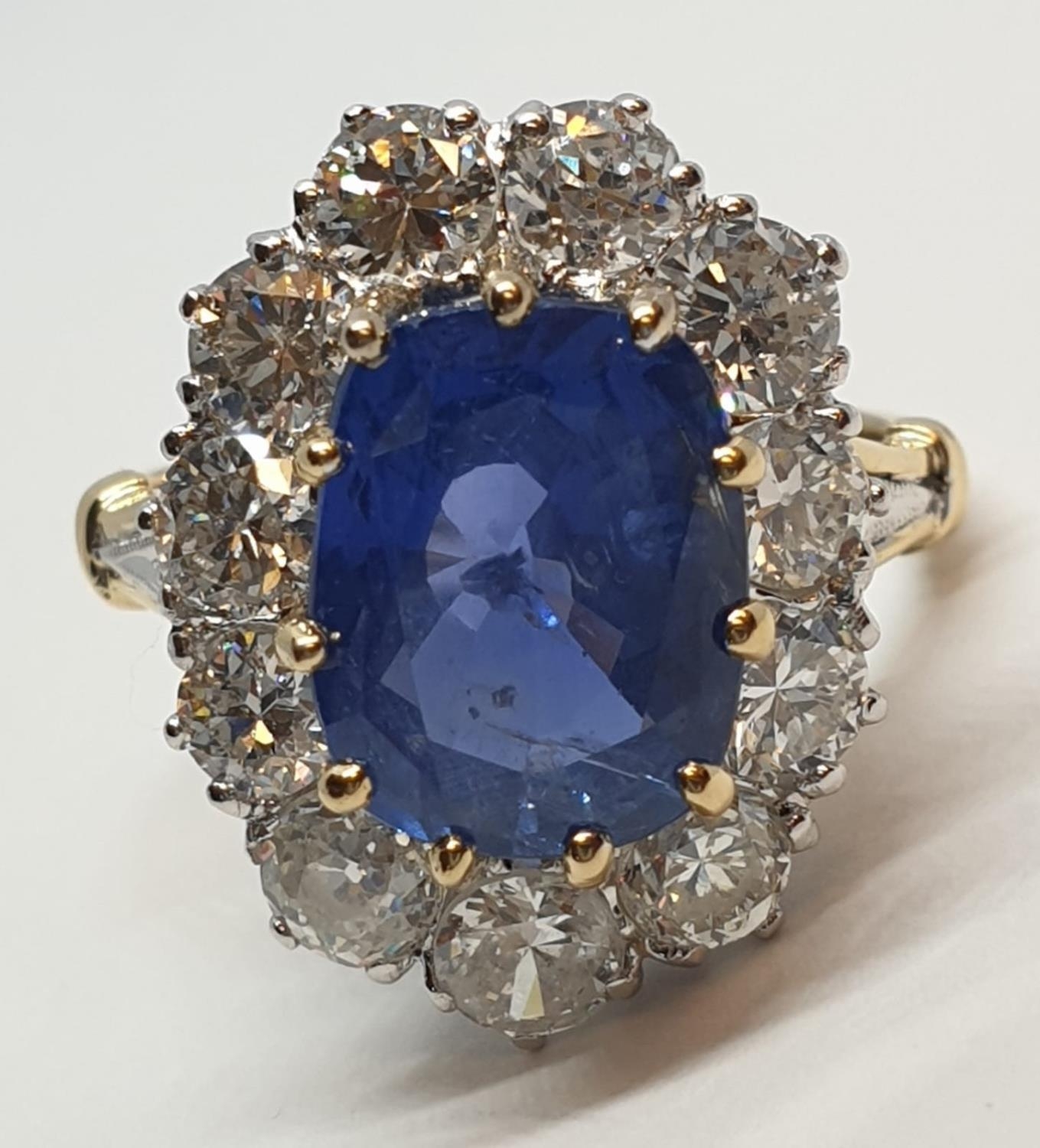 5.75ct sapphire ring set in white and yellow gold with over 3.5ct diamonds surrounding, weight 6.