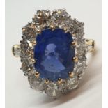 5.75ct sapphire ring set in white and yellow gold with over 3.5ct diamonds surrounding, weight 6.