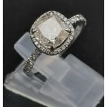 A Breathtaking 18K White Gold and Diamond Ring. A central 1.96ct cushion-cut central stone with 44