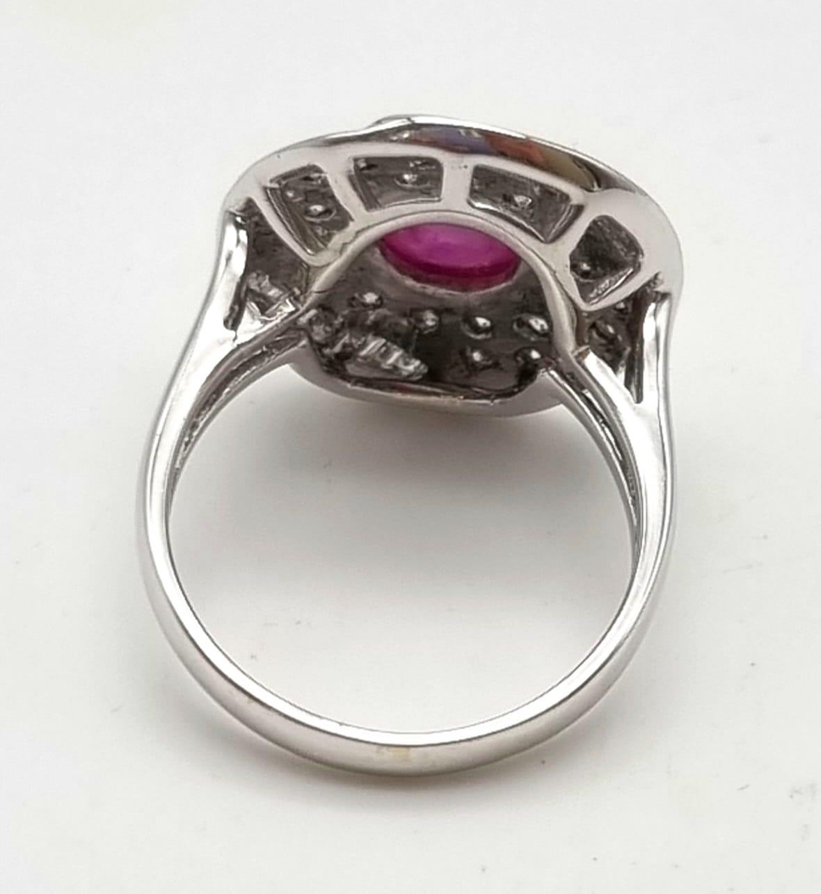 An 18K White Gold Burma Star Ruby and Diamond Ring. Central Burma Star ruby surrounded by a - Image 4 of 7