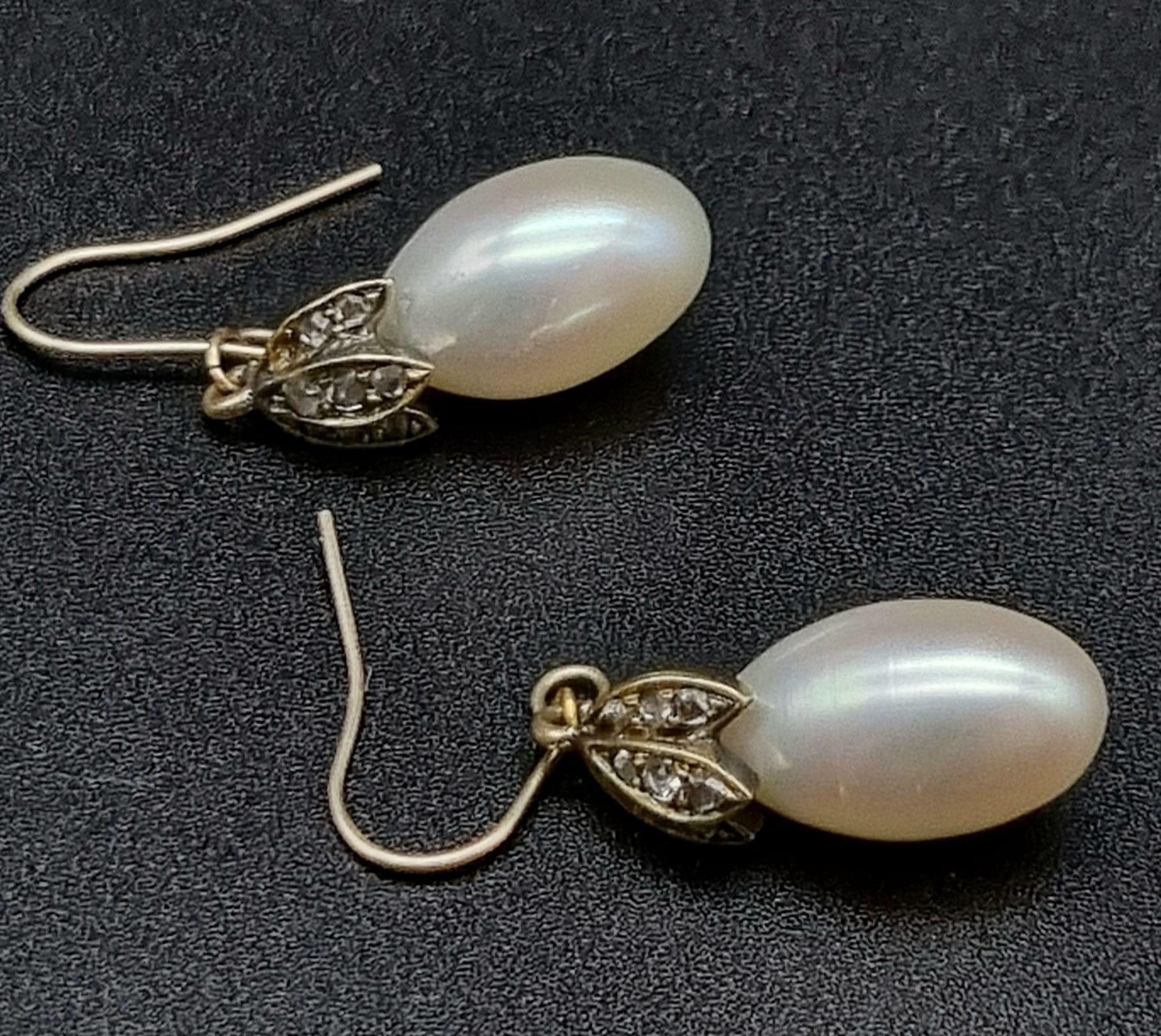 A Pair of Rose Diamond and Pearl Earrings. Oval shaped pearls with three leaves of rose diamonds.