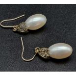 A Pair of Rose Diamond and Pearl Earrings. Oval shaped pearls with three leaves of rose diamonds.