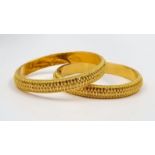 Two 916 Yellow Gold Asian Styled Bangles. Decorated with a wonderful geometric pattern. 6cm inner