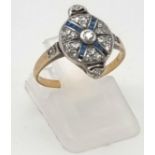 A Stylish Art Deco 18K Gold Diamond and Sapphire Ring. 1.5ct of diamonds with sapphire cross stones.