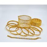 An Eclectic 22K Yellow Gold Mix of Ten Bangles and One Bracelet. Bangles: Eight, the same design and