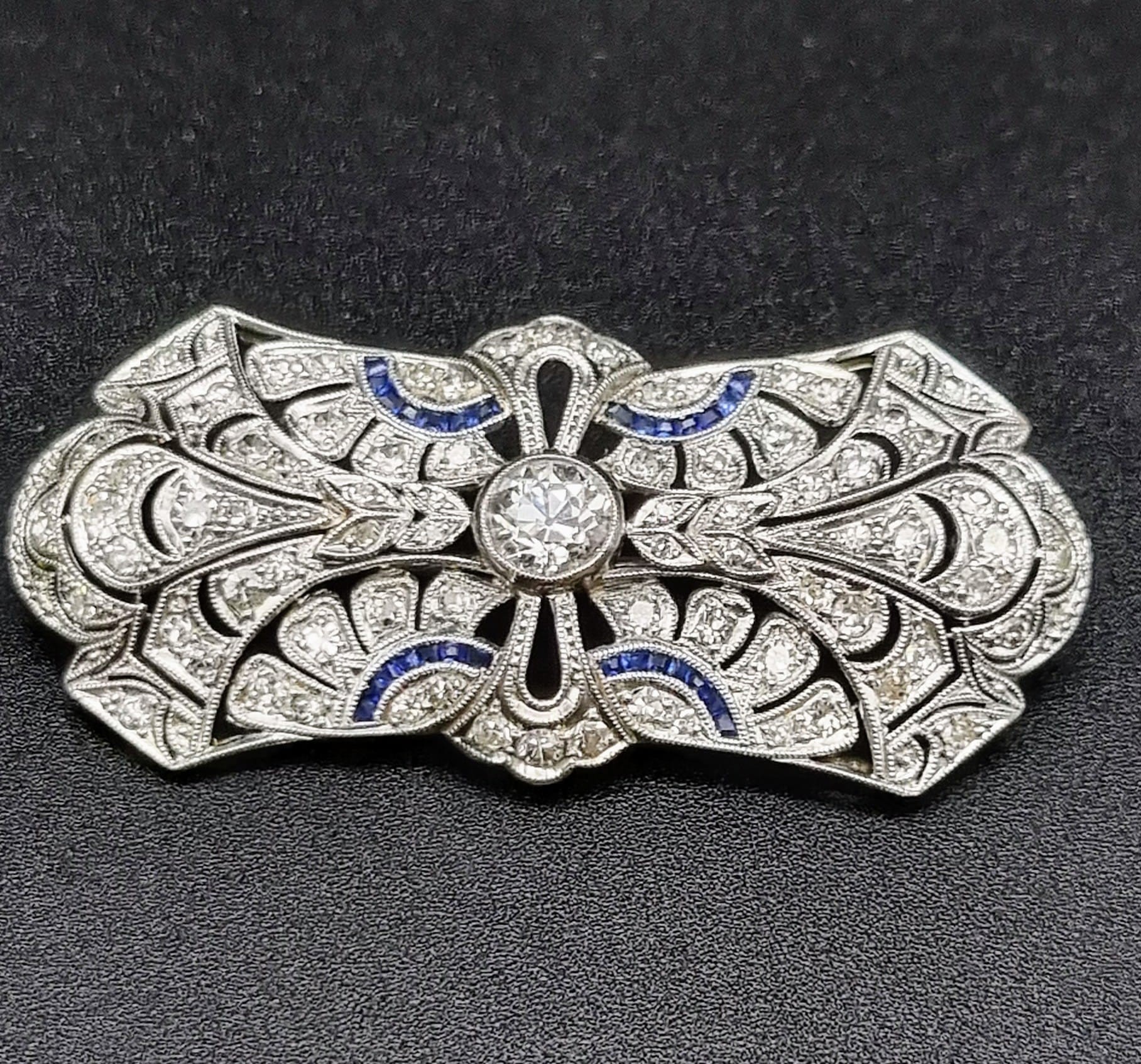 A Vintage Art Deco Diamond and Sapphire Brooch. Butterfly design with large central diamond