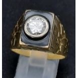 A Striking 18K Yellow Gold Black Enamel and Diamond Ring. Round brilliant cut central diamond 1.