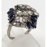 A Wonderful 18K White Gold Sapphire and Diamond Ring. Exquisite floral design with ten sapphires and