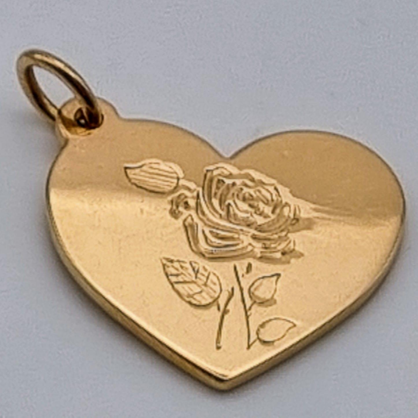 A TIFFANY 18K ROSE GOLD HEART PENDANT WITH ROSE ENGRAVING. 7.8gms