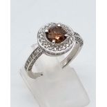 A 14K White Gold Champagne Diamond Ring. Champagne diamond centre stone -1ct surrounded by a halo of