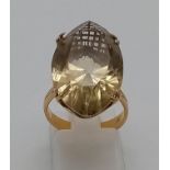 AN 18K YELLOW GOLD AND CITRINE DRESS RING . 8gms size N