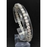 A Spectacular 14k White Gold 15.5ct Diamond Tennis Bracelet. 37 excellent cut VS diamonds make