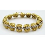 An 18K Yellow Gold Platinum and Diamond Bracelet. Markings for Vahe Naltchatan. 15 diamonds. 18cm.