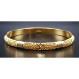 A 22K Yellow Gold Bangle with Geometric Decoration. 6cm inner diameter. 14.7g.