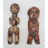 A pair of antique 19th century African ivory fertility figurines from the Lega tribe in the Congo.