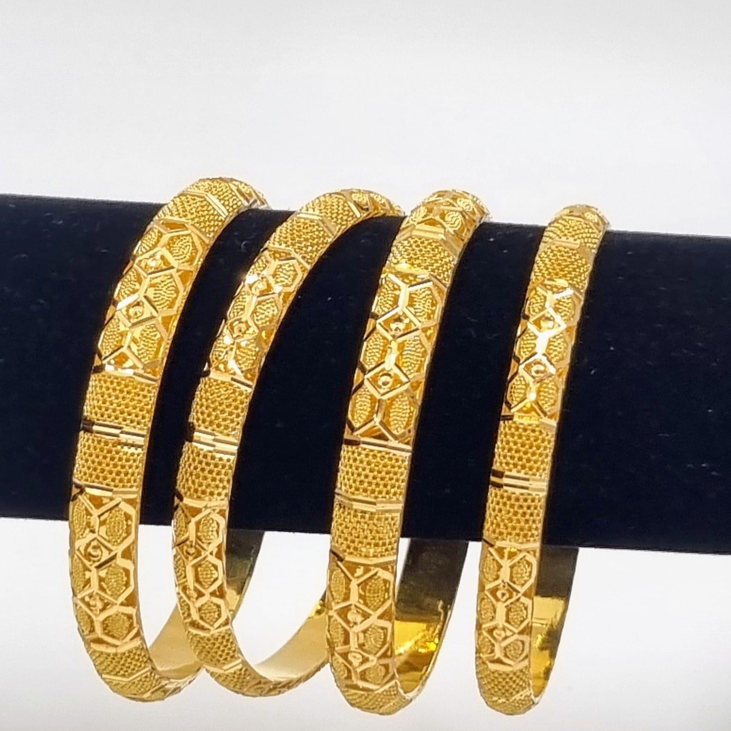 Four 22k Yellow Gold Asian Wedding Bangles. Geometric pierced decoration throughout. 6.5cm inner