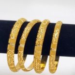 Four 22k Yellow Gold Asian Wedding Bangles. Geometric pierced decoration throughout. 6.5cm inner