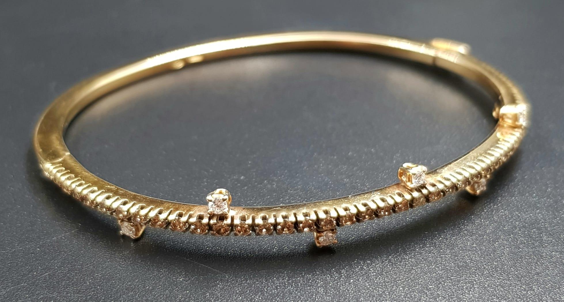 A VI NTAGE 18K ROSE GOLD AND DIAMOND BANGLE WITH BEAUTIFULLY DESIGNED DIAMONDS. 13.6gms