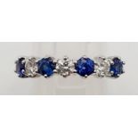 An 18K Yellow Gold Diamond and Sapphire Seven-Stone Ring. 0.35ct diamonds. Stunning clean stones.