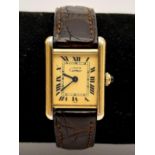 A Must de Cartier Ladies Tank Watch. Cartier leather strap. Silver gold plated case - 22 x 28mm.