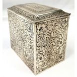 AN ANTIQUE SILVER TEA CADDY DATED 1909 WITH HAND CHASED FLORAL DESIGN ON ALL SIDES , HINGES AND