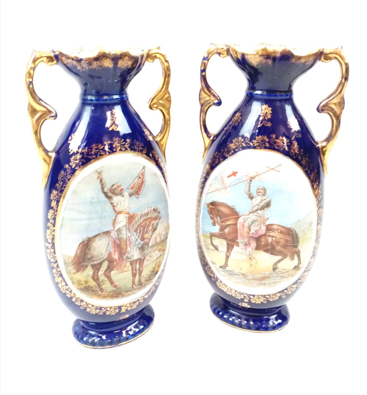 A VERY EARLY PAIR OF MACINTIRE BLUE GLAZED AND GILT VASES WITH CRUSADER PICTURES. 32cms tall.