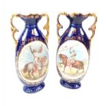 A VERY EARLY PAIR OF MACINTIRE BLUE GLAZED AND GILT VASES WITH CRUSADER PICTURES. 32cms tall.