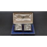 An Antique Solid Silver Pair of Napkin Rings - decorated with repousse cherubic angel scenes.