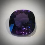 A 20ct Montana Deep-Purple Sapphire. Cushion cut with no visible marks or inclusions. 16 x 16 x 8mm.