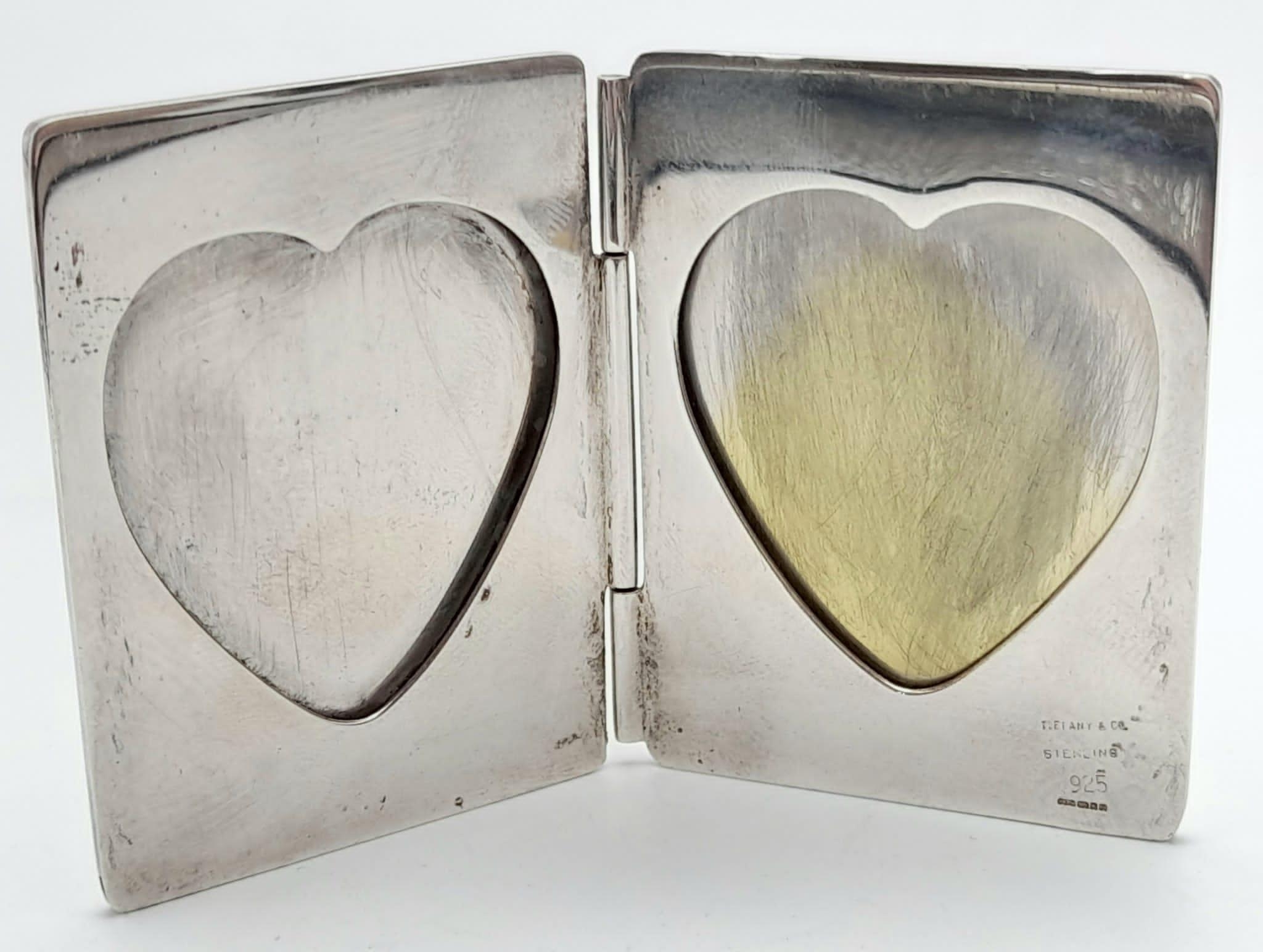 A Vintage Tiffany and Co Double Heart Silver Picture Frame. Heart shaped photo holes on interior.