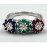 An 18K White Gold Diamond, Emerald, Ruby and Sapphire Triple Floral Design Cluster Ring. Gorgeous,