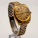 A Vintage Bulova Accutron Gents Watch. Gold plated strap and case - 38mm. Gold dial with day and