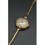 A vintage, ladies, watch, 9 K rose gold in good working order. Dial 25 mm, silver face. Total