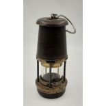 An antique W M Maurice Ltd of Sheffield miners lamp with internal flint spark igniter, this model is