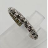 An unusual, 9 K white gold, eternity ring with diamonds. Ring size: L, weight: 2.25 g.