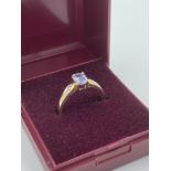 9 carat GOLD and TANZANITE RING, having oval Tanzanite solitaire with diamond point shoulders.