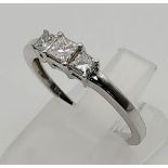 An 18 K white gold ring with a trilogy of square diamonds. Ring size: N, weight: 2.43 g.