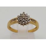 A 9 K yellow ring with a cluster of diamonds. Ring size: N, weight: 2.11 g.