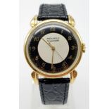 14K YELLOW GOLD MOVADO WATCH, CIRCULAR FACE GOLD DIAL 32MM, MANUAL WIND AND BLACK STRAP