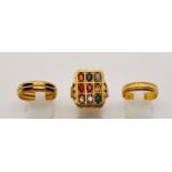 Three 22K Yellow Gold Rings: A large rectangular signet ring with nine gemstones - size S. A band