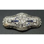 A beautiful Art deco 18 K white gold brooch with Diamonds and blue sapphires. Dimensions: 44 x 21