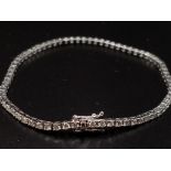 AN 18K WHITE GOLD AND 3CT DIAMOND TENNIS BRACELET. 7.4gms