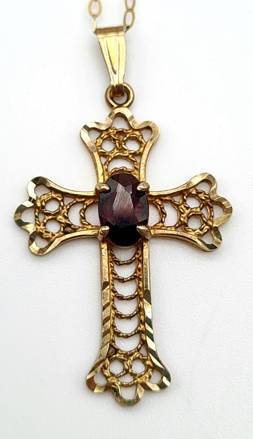 A 9K Yellow Gold Cross with Garnet Centre Stone on a 9K Yellow Gold Disappearing Necklace. 25mm